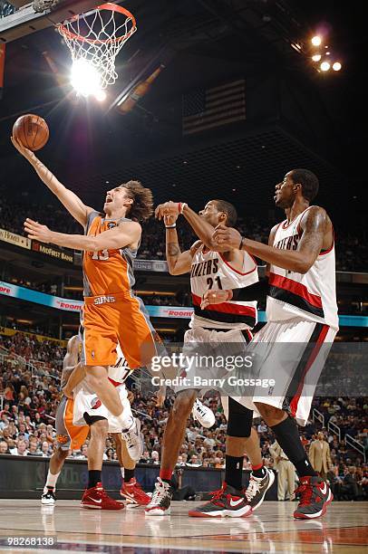 Steve Nash of the Phoenix Suns shoots a layup against Marcus Camby and LaMarcus Aldridge of the Portland Trail Blazers during the game at U.S....