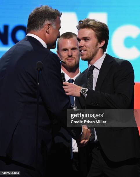 Hockey Hall of Fame member Eric Lindros and Daniel Sedin of the Vancouver Canucks present Connor McDavid of the Edmonton Oilers with the Ted Lindsay...