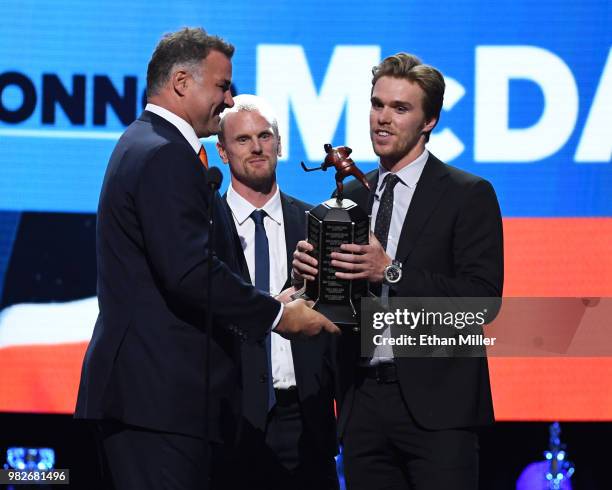 Hockey Hall of Fame member Eric Lindros and Daniel Sedin of the Vancouver Canucks present Connor McDavid of the Edmonton Oilers with the Ted Lindsay...
