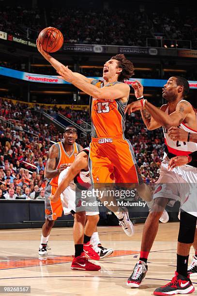 Steve Nash of the Phoenix Suns shoots a layup against Marcus Camby of the Portland Trail Blazers during the game at U.S. Airways Center on March 21,...