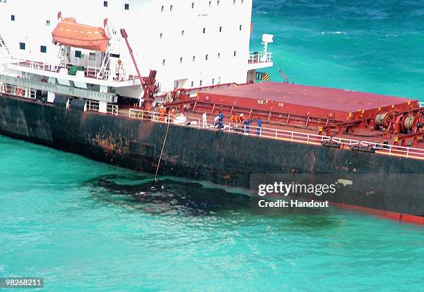 Fuel oil leaks from the Shen Neng 1, a Chinese-registered bulk coal carrier grounded in the Great Barrier Reef Marine Park on April 4 off the coast...