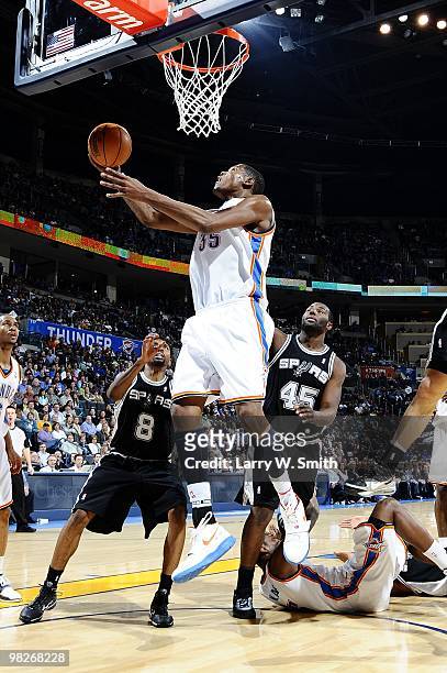 Kevin Durant of the Oklahoma City Thunder shoots a layup against Roger Mason Jr. #8 and DeJuan Blair of the San Antonio Spurs during the game at Ford...