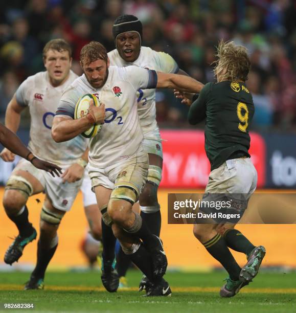 Chris Robshaw of England is held by Faf de Klerk during the third test match between South Africa and England at Newlands Stadium on June 23, 2018 in...