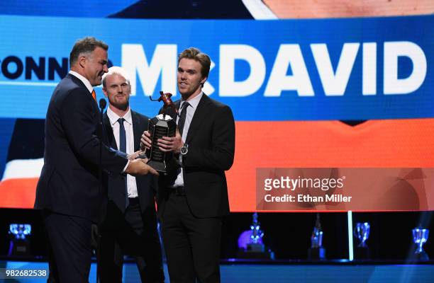 Hockey Hall of Fame member Eric Lindros and Daniel Sedin of the Vancouver Canucks present Connor McDavid of the Edmonton Oilers with the Ted Lindsay...