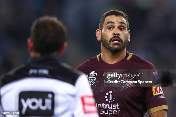 Greg Inglis of Queensland talks to referee Gerard Sutton during game two of the State of Origin series between the New South Wales Blues and the...