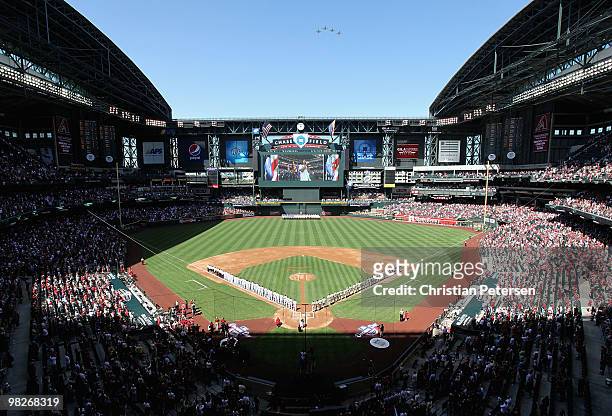 The Arizona Diamondbacks and the San Diego Padres stand attended as country singer Joe Nichols performs the National Anthem before the Opening Day...