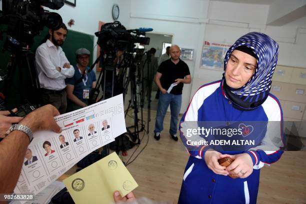 Woman casts her ballot at a polling station during snap twin Turkish presidential and parliamentary elections in Ankara on June 24, 2018. - Turks...