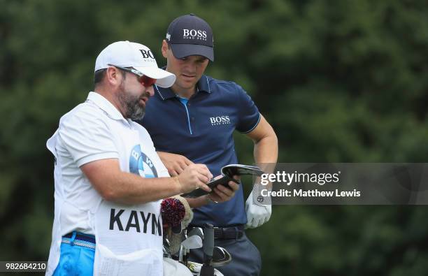 Martin Kaymer of Germany looks on with his caddie during day four of the BMW International Open at Golf Club Gut Larchenhof on June 24, 2018 in...