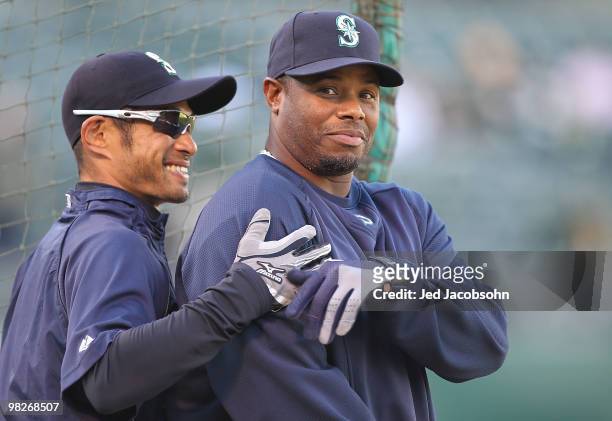 Ichiro Suzuki and Ken Griffey Jr. #24 of the Seattle Mariners look on during batting practice against the Oakland Athletics on Opening Day at the...