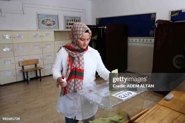 Woman casts her ballot at a polling station during snap twin Turkish presidential and parliamentary elections in Ankara on June 24, 2018. - Turks...