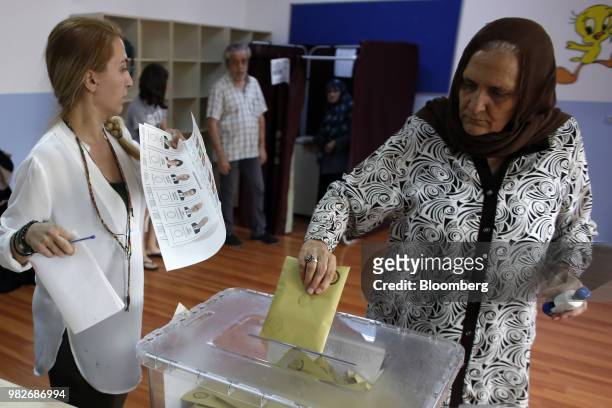 Woman casts her vote in a ballot box at a polling station during parliamentary and presidential elections in the district of Uskudar, Istanbul,...