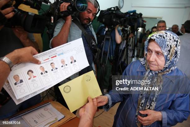 Woman gets ready to cast her ballot at a polling station during snap twin Turkish presidential and parliamentary elections in Ankara, on June 24,...