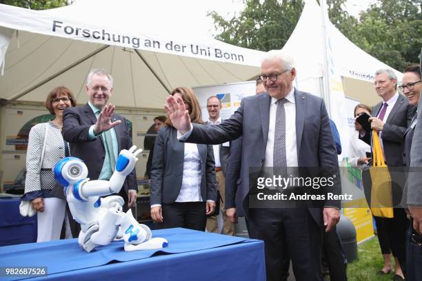 German President Frank-Walter Steinmeier waves to a robotor upon his visit at Research University of Bonn booth during the open-house day at Villa...
