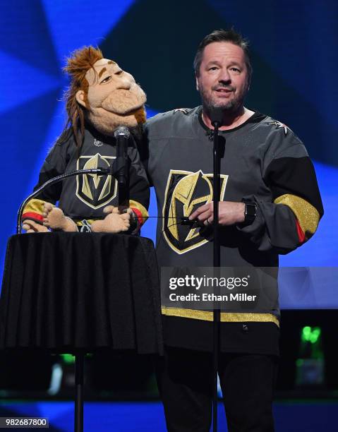 Comic ventriloquist and impressionist Terry Fator performs with his puppet Duggie Scott Walker as he presents an award at the 2018 NHL Awards...