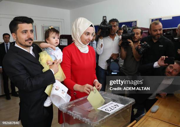 Family cast their ballots at a polling station during snap twin Turkish presidential and parliamentary elections in Ankara, on June 24, 2018. - Turks...