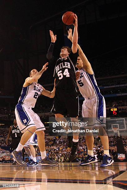 Matt Howard of the Butler Bulldogs attempts a shot against Miles Plumlee and Mason Plumlee of the Duke Blue Devils during the 2010 NCAA Division I...