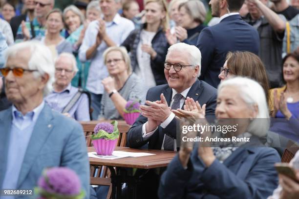 German President Frank-Walter Steinmeier takes a rest and listen to a talk of First Lady Elke Buendenbender and Eckart von Hirschhausen during the...