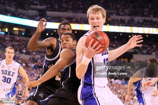 Kyle Singler of the Duke Blue Devils with the ball against Ronald Nored of the Butler Bulldogs in the first half during the 2010 NCAA Division I...