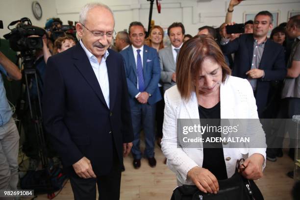 Kemal Kilicdaroglu, the leader of Turkey's main opposition Republican People's Party and his wife Selvi Kilicdaroglu stand at a polling station...