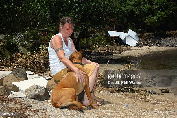 Owner Wendy Booth and her dog look on at the devastation of her destroyed Seabreeze resort following the 8.3 magnitude strong earthquake which struck...
