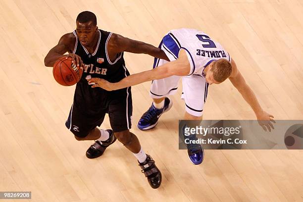 Shelvin Mack of the Butler Bulldogs moves the ball as Mason Plumlee of the Duke Blue Devils goes for a steal in the first half during the 2010 NCAA...