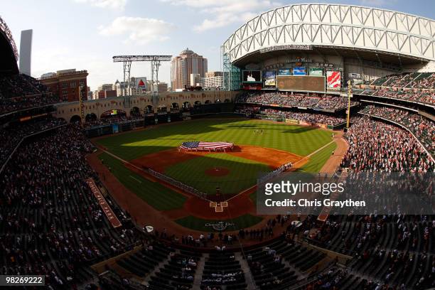 Members of the San Francisco Giants and the Houston Astros stand on the field during pre-game activites on Opening Day at Minute Maid Park on April...