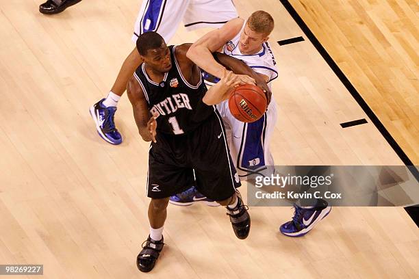 Shelvin Mack of the Butler Bulldogs and Mason Plumlee of the Duke Blue Devils battle for the ball in the first half during the 2010 NCAA Division I...