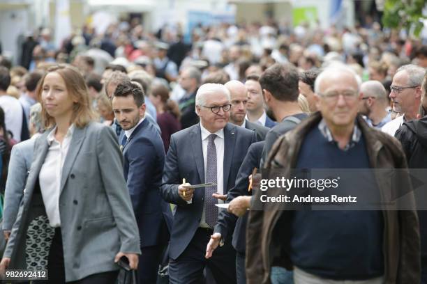 German President Frank-Walter Steinmeier signs autographs for the visitors during his walk at the open-house day at the Villa Hammerschmidt on June...