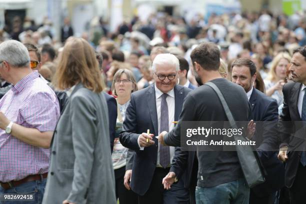 German President Frank-Walter Steinmeier signs autographs for the visitors during his walk at the open-house day at the Villa Hammerschmidt on June...