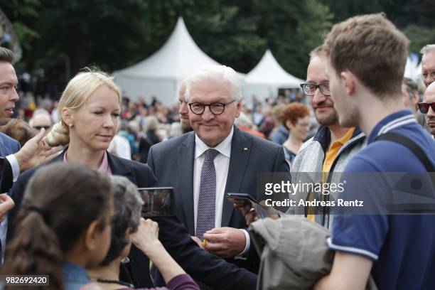 German President Frank-Walter Steinmeier signs autographs for the visitors during his walk at the open-house day at the Villa Hammerschmidt on June...