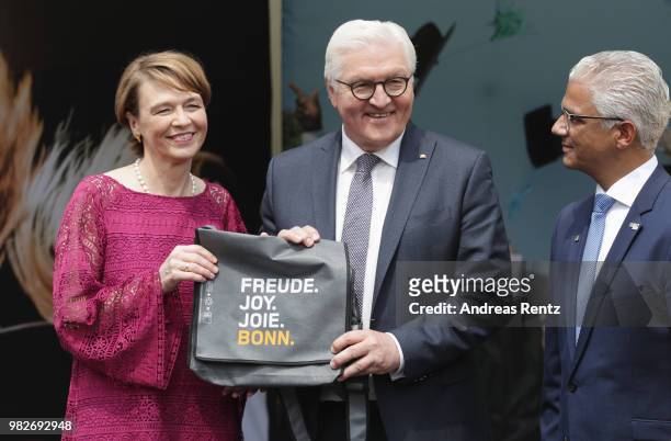 German President Frank-Walter Steinmeier with First Lady Elke Buendenbender receive a gift by Ashok-Alexander Sridharan, Mayor of Bonn smile during...