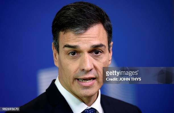 Spain's Prime Minister Pedro Sanchez addresses media representatives as he arrives ahead of a summit at EU headquarters in Brussels on June 24, 2018....