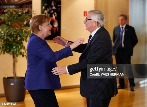 German Chancellor Angela Merkel is welcomed by European Commission President Jean-Claude Juncker ahead of a summit at EU headquarters in Brussels on...