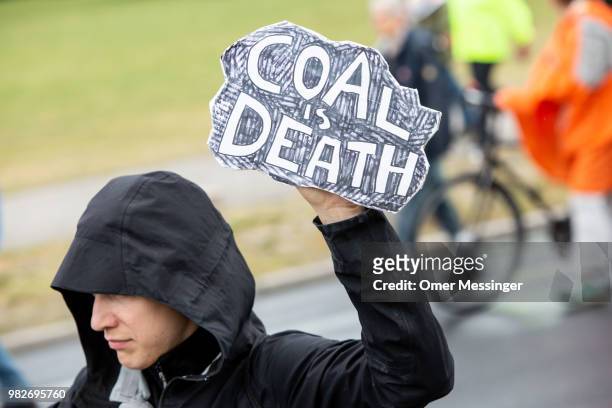 Demonstrators march to protest against coal-based energy near the Chancellery during a "Stop Coal" protest on June 24, 2018 in Berlin, Germany. While...