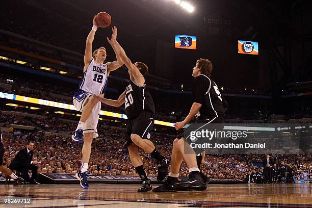 Kyle Singler of the Duke Blue Devils drives for a shot attempt in the second half against Gordon Hayward of the Butler Bulldogs during the 2010 NCAA...