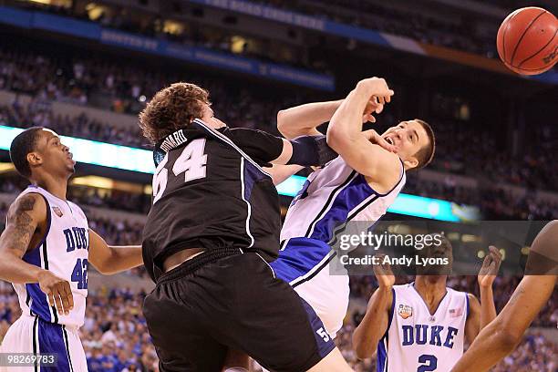 Matt Howard of the Butler Bulldogs fouls Miles Plumlee of the Duke Blue Devils in the second half during the 2010 NCAA Division I Men's Basketball...