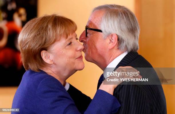 German Chancellor Angela Merkel is welcomed by European Commission President Jean-Claude Juncker for a summit at the EU headquarters in Brussels on...