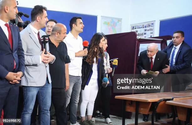 Devlet Bahceli, Leader of Turkey's Nationalist Movement Party comes out of a voting booth at a polling station during snap twin Turkish presidential...