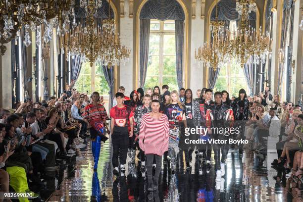 Designer Olivier Rousteing walks the runway with models during the finale of the Balmain Menswear Spring/Summer 2019 show as part of Paris Fashion...