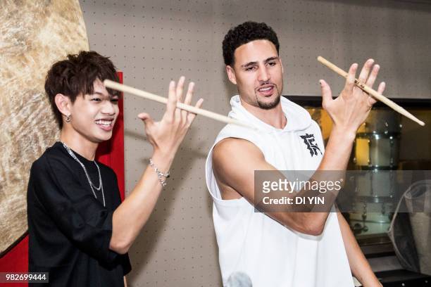 Player Klay Thompson of the Golden State Warriors play a drumstick with a musician on June 24, 2018 in Beijing, China.