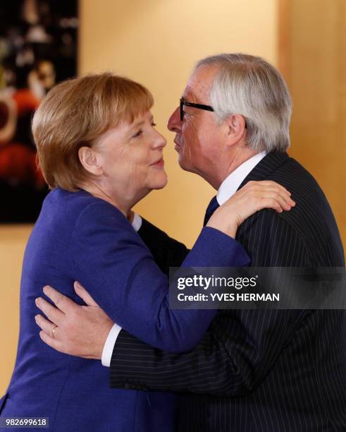 German Chancellor Angela Merkel is welcomed by European Commission President Jean-Claude Juncker for a summit at the EU headquarters in Brussels on...