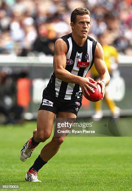 Luke Ball of the Magpies runs with the ball during the round two AFL match between the Collingwood Magpies and the Melbourne Demons at the Melbourne...