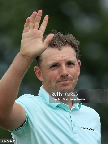 Matt Wallace of England celebrates holing his putt on the the 18th hole during the fourth round of the BMW International Open at Golf Club Gut...