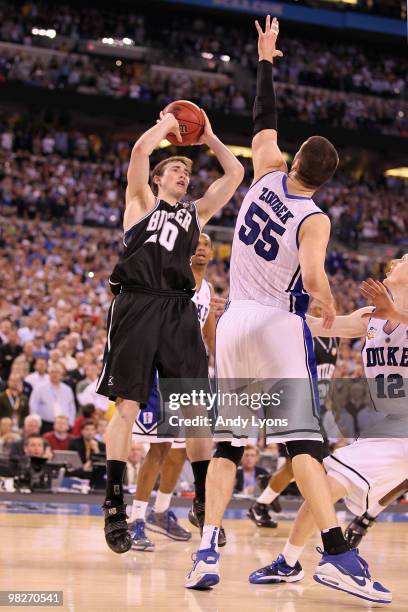 Gordon Hayward of the Butler Bulldogs shoots over Brian Zoubek of the Duke Blue Devils in the final ten seconds during the 2010 NCAA Division I Men's...