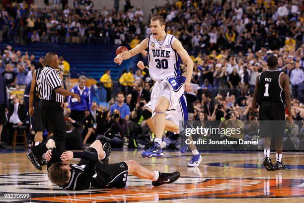 Jon Scheyer of the Duke Blue Devils celebrates after they won 61-59 against Matt Howard of the Butler Bulldogs during the 2010 NCAA Division I Men's...