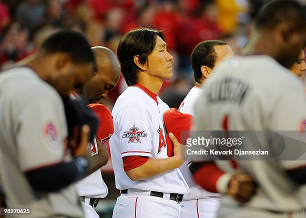 Hideki Matsui of the Los Angeles Angels of Anaheim stands during the national anthem prior to their game against the Minnesota Twins on Opening Day...