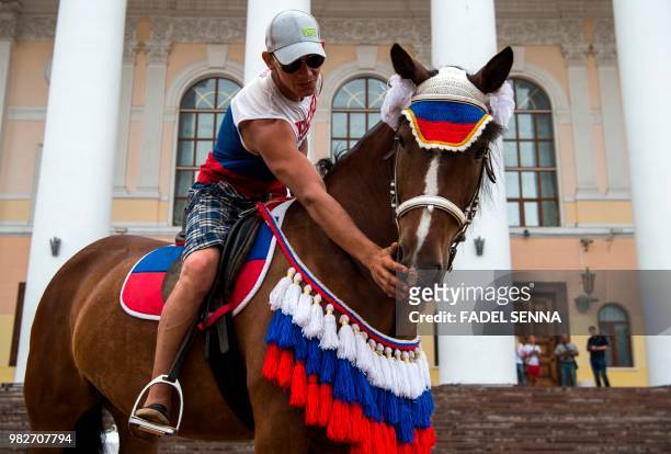 Man rides a horse kitted out in a Russian tricolor-themed outfit in the town of Kaluga, southwest of Moscow, on June 24 during the Russia 2018 World...