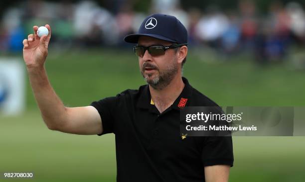 Mikko Korhonen of Finland celebrates holing out on the 18th hole during the fourth round of the BMW International Open at Golf Club Gut Larchenhof on...