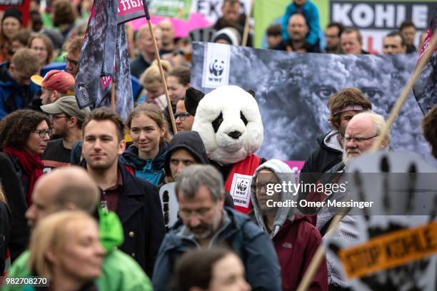 Demonstrators gather to protest against coal-based energy in front of the Chancellery in the "Stop Coal" protest event on June 24, 2018 in Berlin,...