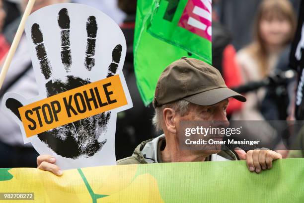 Demonstrators gather to protest against coal-based energy in front of the Chancellery in the "Stop Coal" protest event on June 24, 2018 in Berlin,...